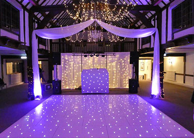 DJ with Equipment, Dance Floor and Giant Letters